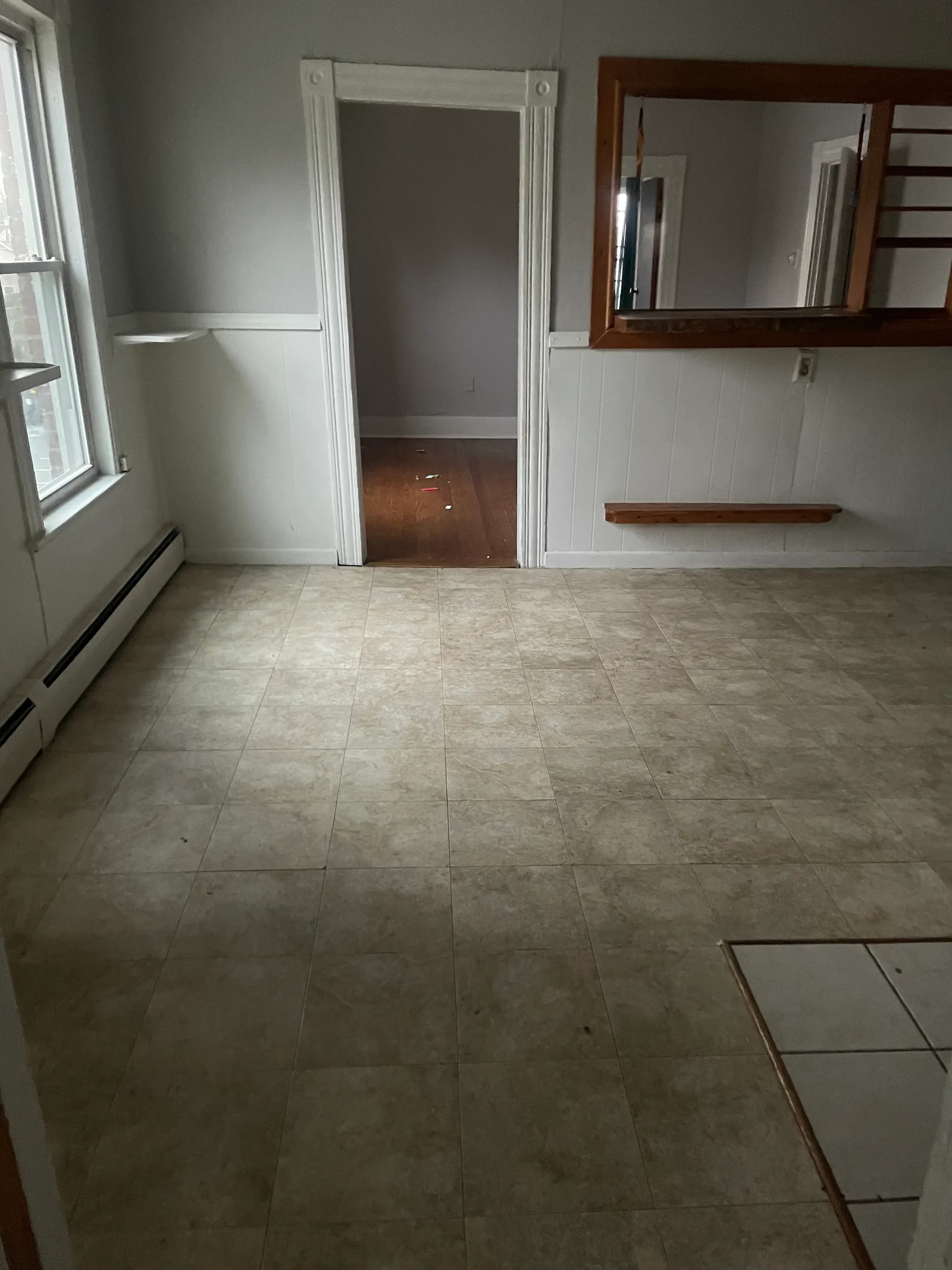 A cleared, swept room with a tiled floor, ready for the next chapter.
