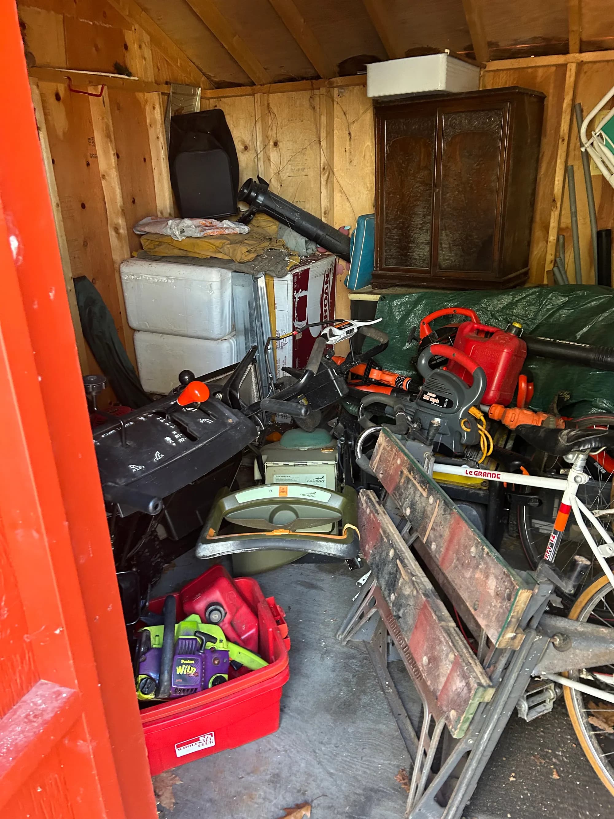 A storage shed of tools and equipment being sorted during a move.